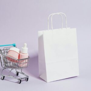 A minimalist image featuring a shopping cart with cosmetics and a white paper bag, ideal for Black Friday promotions.